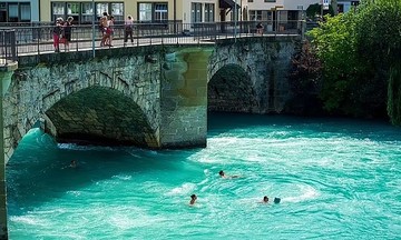 Cooling off on the commute: Swiss workers swim home