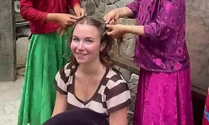 Children braiding hair and asking for money from tourists in Ha Giang