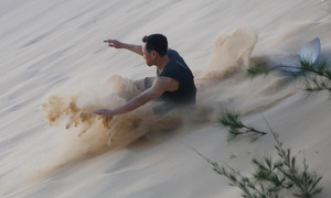 Sandboarding on Quang Phu dunes