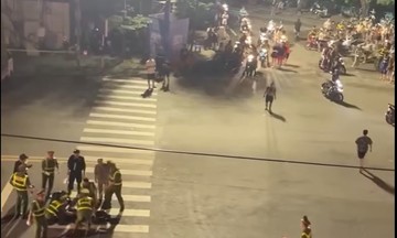 Two men crash motorcycle into traffic police officer