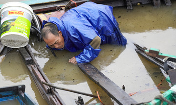 Fishermen salvage belongings after typhoon Kajiki sinks dozens of boats