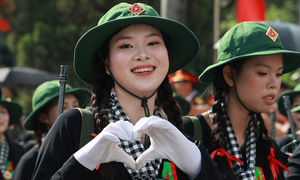 Soldiers share the love with heart gestures during parade
