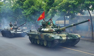 Armored vehicles participate in the A80 parade