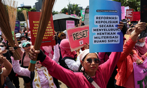 Indonesian women protest with brooms