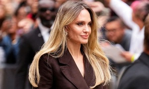 Angelina Jolie shows off her legs in a trench coat
