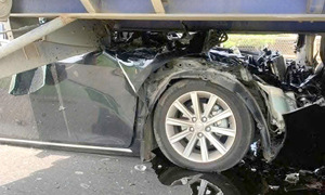 Four-passenger car mangled in multi-vehicle collision
