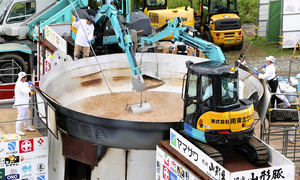 Giant taro soup stirred by excavator at Japanese festival