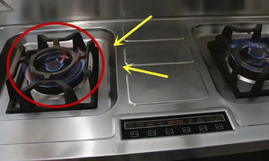 Why is the left gas burner not ideal for stir-frying?