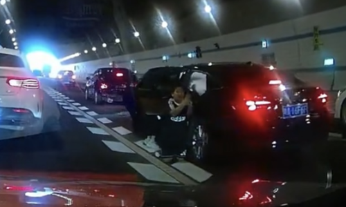 10-year-old boy kneels crying in street, pleads for mother's life
