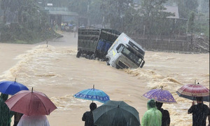 Tractor-trailer swept away by floodwaters