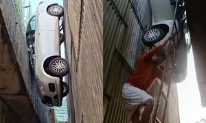 Car falls between two pillars of an under-construction overpass