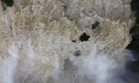 Pongour waterfall rages with murky floodwaters