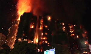 Hong Kong firefighters contain apartment fire over two days