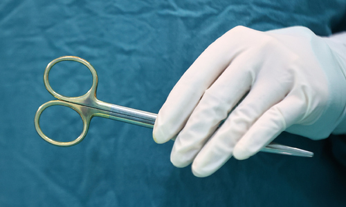 Two-year-old child bitten by family dog, sustaining lip and ear injuries