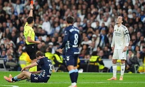 Why did Real receive three red cards in their home loss?