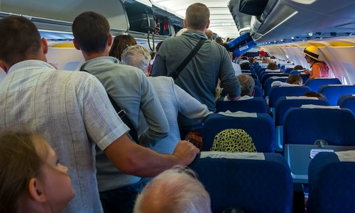 Passengers' habit of rushing to the aisle immediately after landing
