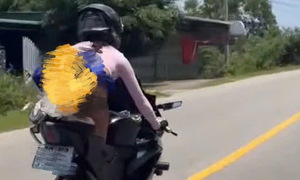 Female tourist investigated for performing motorcycle stunts including 'kneeling, lying on seat'