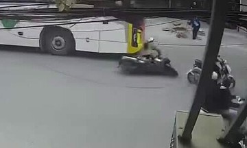 Woman on motorbike dragged under passenger bus