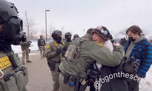 US agent draws attention for leaving ranks to hug protester in Minnesota
