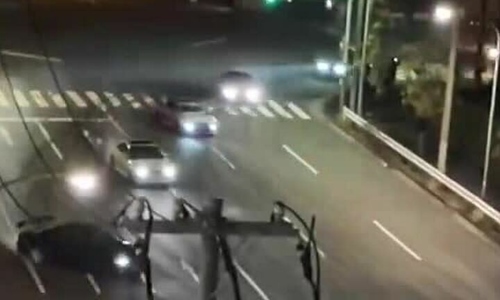 A series of cars drift in a scene straight out of a movie