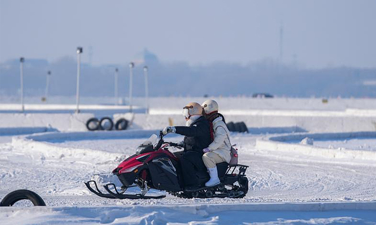 Visitors experience motorcycle and car drifting on Harbin's frozen river