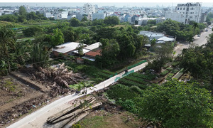 Bridge unfinished for eight years, residents fill canal to create temporary road