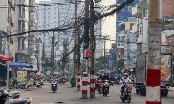 A series of power poles obstruct newly widened road in downtown Ho Chi Minh City