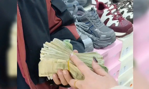 A boy collects loose change to buy new shoes for his mother