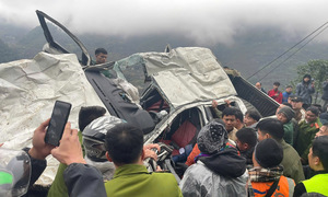 Car crushed after falling into ravine, three people survive