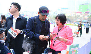 Runners excited holding VnExpress Marathon All-Star bibs