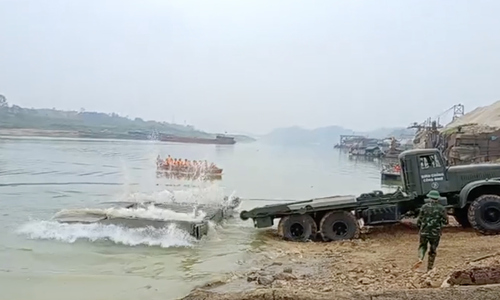 Military engineers deploy pontoon bridge across Lo River for Tet holiday