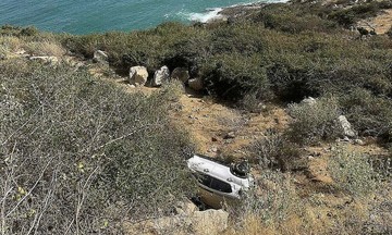 car carrying three people plunges into ravine