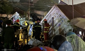 Passenger train collides with container, driver trapped in cabin