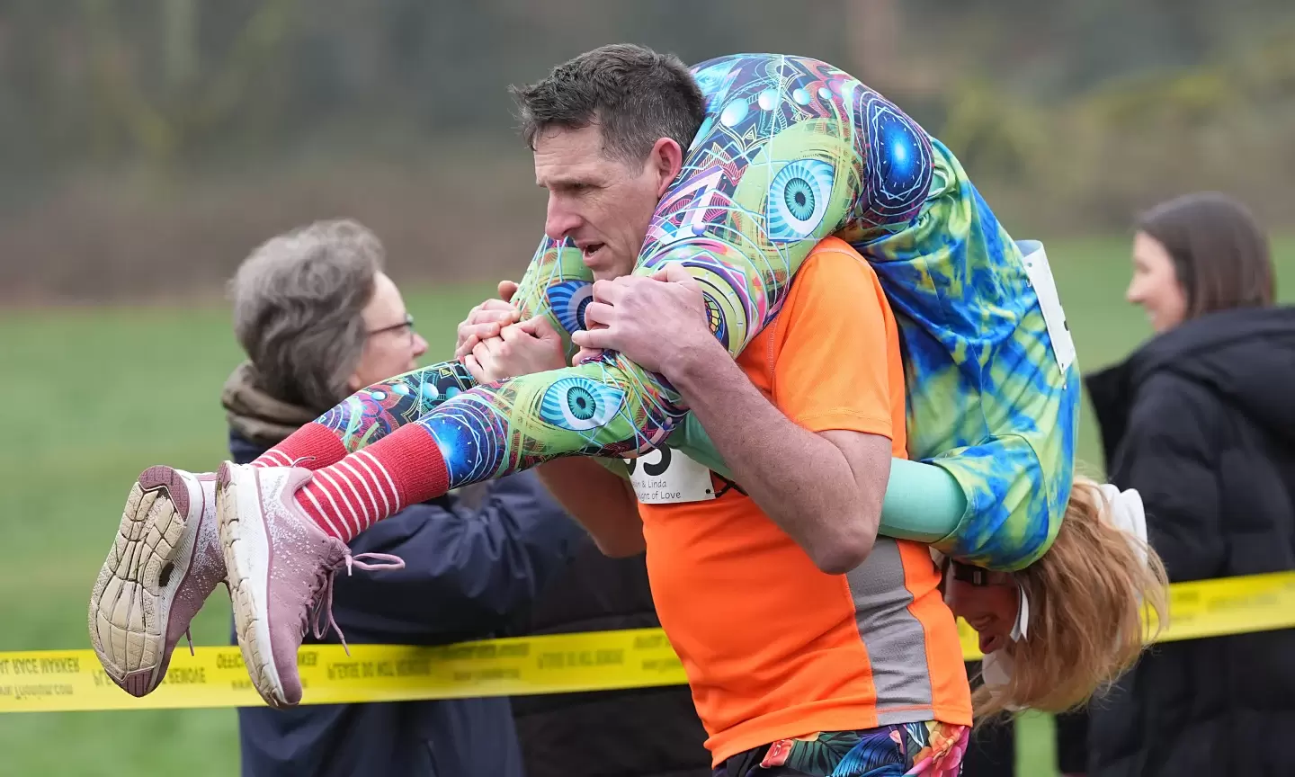 Spectators cheer at wife-carrying competition in England