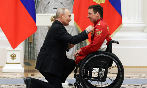 President Putin kneels on one knee to award medal to disabled athlete