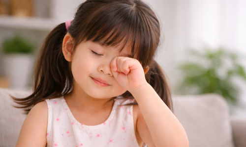 Why do children frequently rub their eyes?