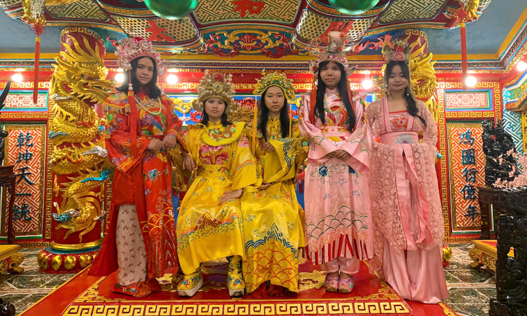 Tourists enjoy wearing imperial robes, sitting on a throne in TP HCM