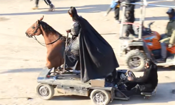 Behind the scenes of a general riding a horse in a historical drama