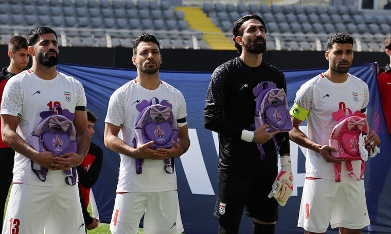 Iran squad holds girls' backpacks to commemorate school bombing