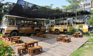 Coffee shop decorated with old buses, cranes in Ho Chi Minh City