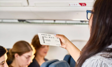 What should passengers do when their seats are changed on a plane?