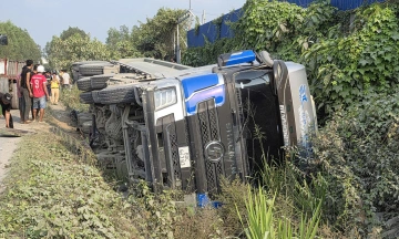Dump truck overturns, crushing car and seriously injuring driver