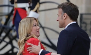 French president draws attention with embrace of Italian prime minister