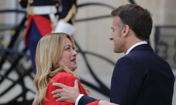 French president draws attention with embrace of Italian prime minister