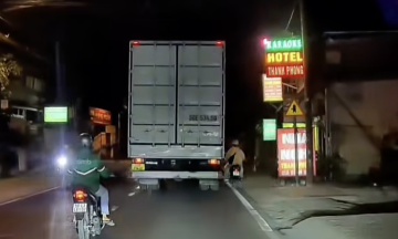 Young man on motorbike tumbles attempting to overtake truck
