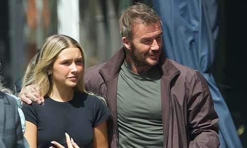 Harper Beckham sports crop top on outing with dad