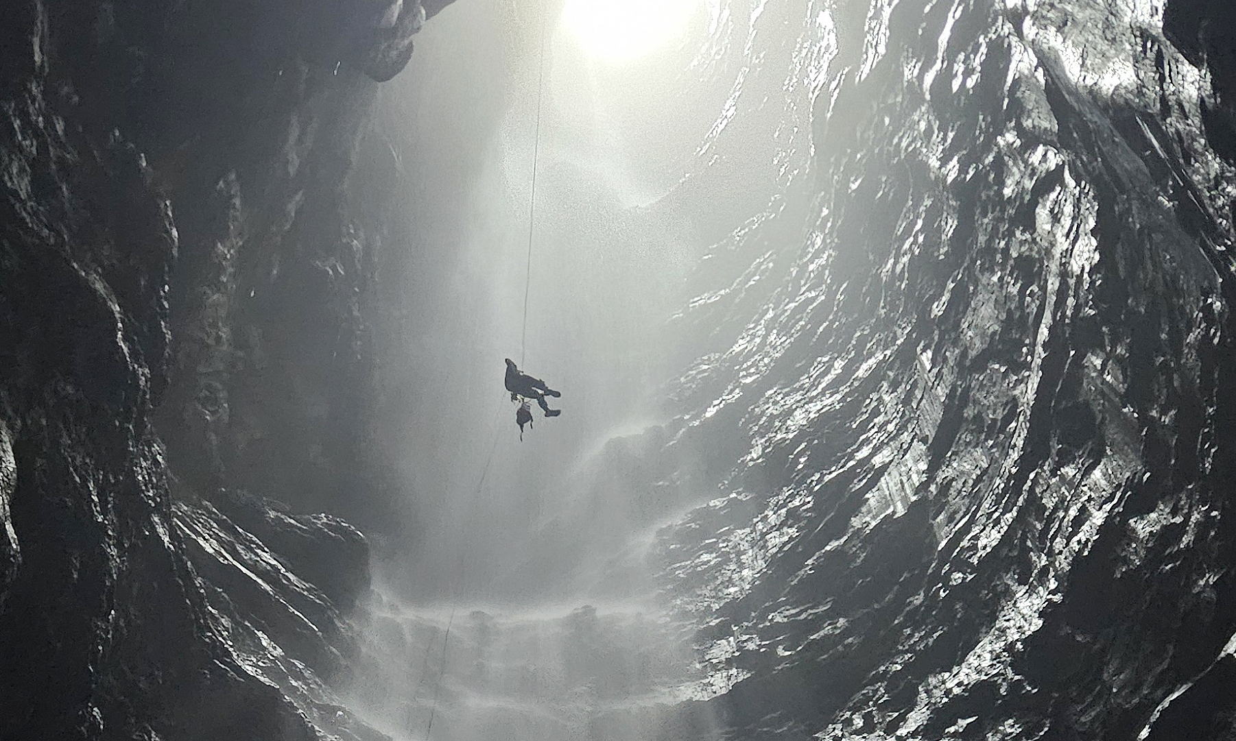 Inside the cave with a 350 m high waterfall