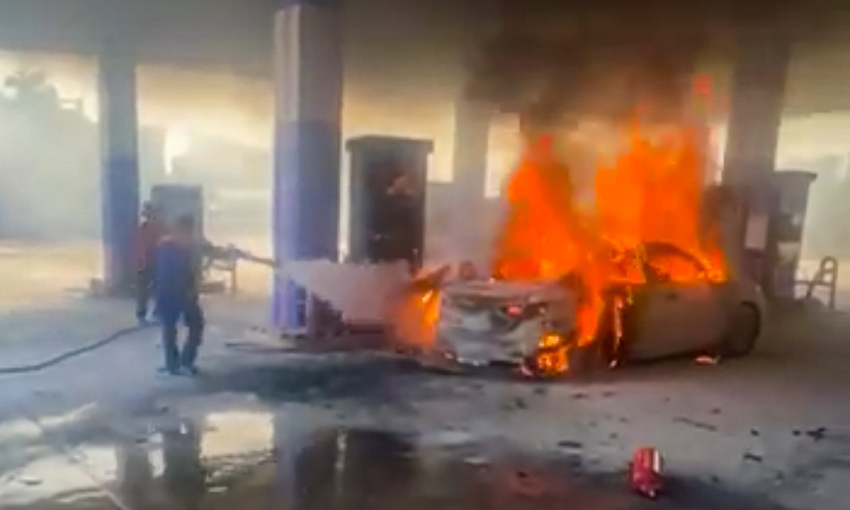 Car fire at gas station claims two lives