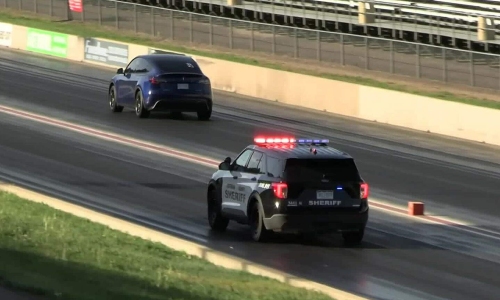 Tesla electric car leaves police vehicle in the dust on the racetrack