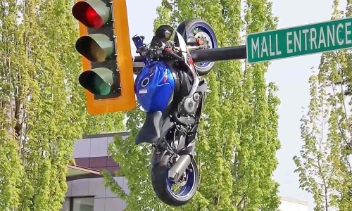 Superbike hangs from traffic light pole after accident